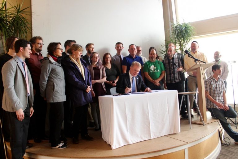 Seattle Mayor Ed Murray signs an open data executive order on Friday at Impact HUB in downtown Seattle.