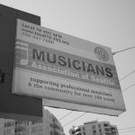 Seattle Musicians Union sign on a building with sky in the background