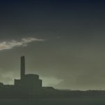Picture of chimney from a factory producing smoke and polluting the air