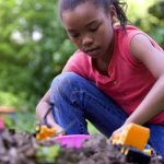 Two children play outside.