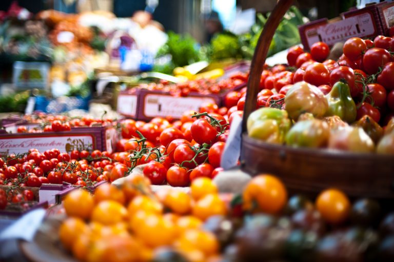 Photo of tomatoes at a market in baskets