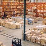 A large warehouse with pallet rack system filled with goods.