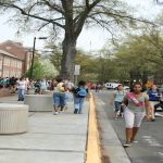 Photo of a busy sidewalk on a school campus
