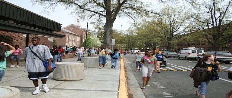Photo of a busy sidewalk on a school campus