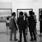 People looking at an art piece in an exhibit