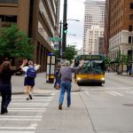 Pedestrians crossing next to bus stop