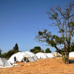Airmen and civilian volunteers construct tents for the three-day Sacramento Stand Down event Sept. 13, 2016, at Rancho Cordova, California.