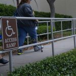 Individuals use a wheelchair-accessible ramp at Joint Base San Antonio-Randolph