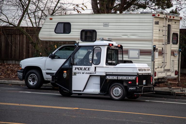 Everett, Washington / USA - 11/16/2018 - Police Parking Enforcement Ticketing vehicle of Boon Docking Homeless Camper