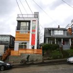 Large modern townhouses rise between houses in the Central District near Garfield High School.