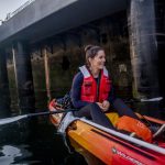 Kerry Accola, a graduate student at the University of Washington's School of Aquatic and Fishery Sciences, tracks salmon with a hydro-acoustic camera, located under her kayak, along the Elliot Bay Seawall between Bell Harbor Marina and Pier 54 in Seattle on June 14, 2019.
