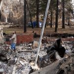 Eric Gowins marvels at the sight of his still-standing fireplace within his decimated home in Paradise, California, Dec. 17, 2018.