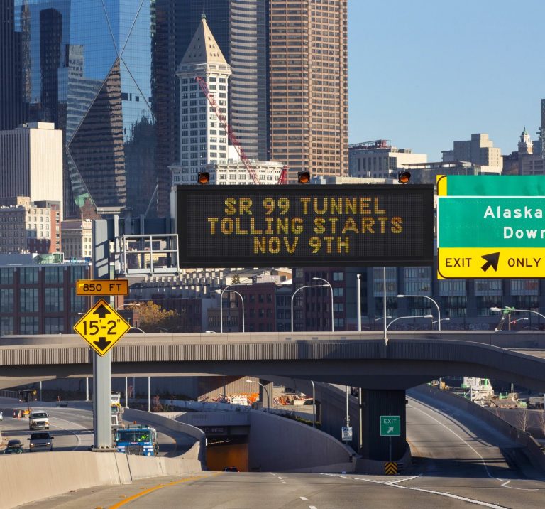 Cars travel south as they exit the Highway 99 tunnel along the Seattle waterfront last month. Tolls will range from $1 overnight and weekends to $2.25 during peak afternoon hours.