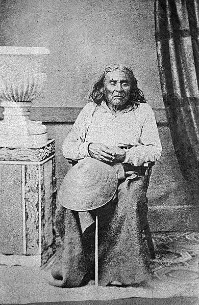 Chief Seattle is seated and facing the camera in a historical photograph.