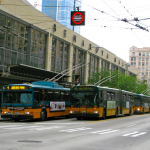 Lines of buses take up two lanes of traffic on 3rd Ave in downtown Seattle.