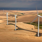 A view of wind turbines in rolling hills.