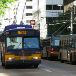 A bus heading through a densely populated area of Seattle.