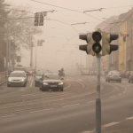 Urban smog caused by transportation and industrial emissions.