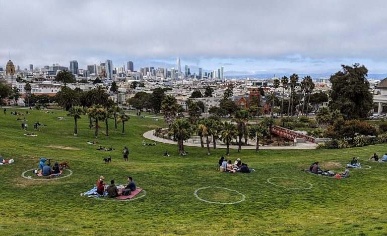 Dolores Park in San Francisco with social-distancing circles painted on the grass to help small family groups stay safely away from each other.