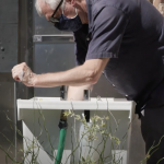 UW Architecture professor Rick Mohler uses a newly installed "street sink" at the ROOTS Young Adult Shelter in the University District, Seattle.