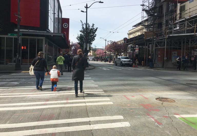 Pedestrians crossing 2nd Ave on Pike St, downtown Seattle.