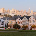 The Painted Ladies in San Francisco, CA with the city skyline in the background.
