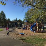 The Burke-Gilman Playground Park. Image shows pathway on the left side of a small playground structure.