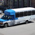 Blue and white paratransit bus parked at Everett Station