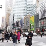 A view of people crossing a street in Times Square, New York.