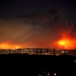 City lights and hills lit up with wildfires in Orange County, 2008.