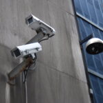 Security cameras attached to concrete building façade.