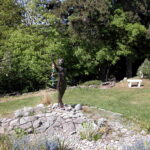 Sadako Sasaki statue in Peace Park in the University District of Seattle, Washington. The bronze statute is of a young girl holding a paper crane in one hand.