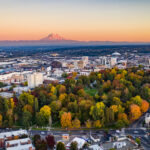 Aerial photo of UW Tacoma, with the campus in the foreground and Mt. Rainier in the distance