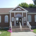 Image of facade of brick library with white trim.